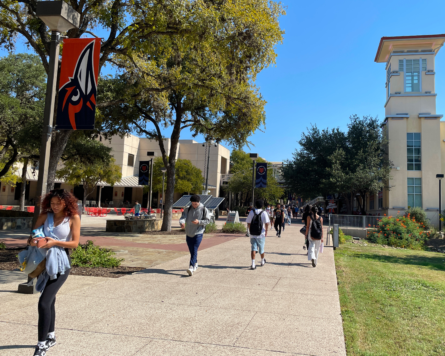 An open walking path with multiple students walking towards or away from the student union.